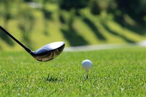 Golf club and a ball sitting on a tee.